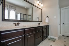 a bathroom with two sinks and a large mirror