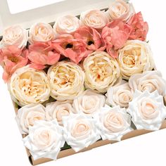 an open box filled with pink and white flowers