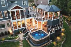 an aerial view of a large house with a pool in the yard and deck area