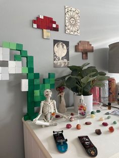 a white table topped with lots of toys and art on top of it's sides