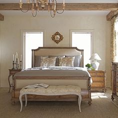 a bedroom with a large bed and chandelier