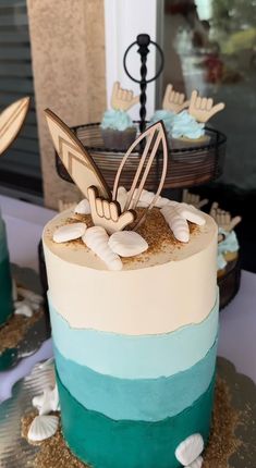 there is a cake that has been decorated with sea shells and starfish on it