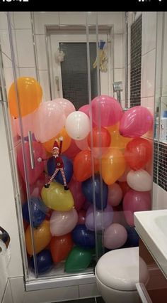 a bathroom with balloons all over the floor