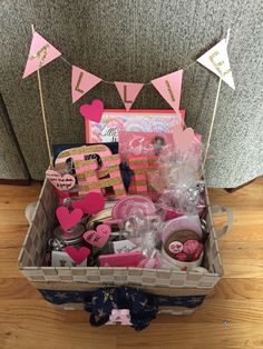 a basket filled with lots of pink and white items