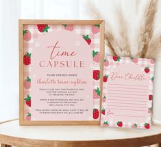 a pink and white strawberry themed birthday party with time capsule cards, strawberries on checkered table cloth