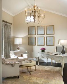 a living room filled with furniture and a chandelier hanging from the ceiling next to a window