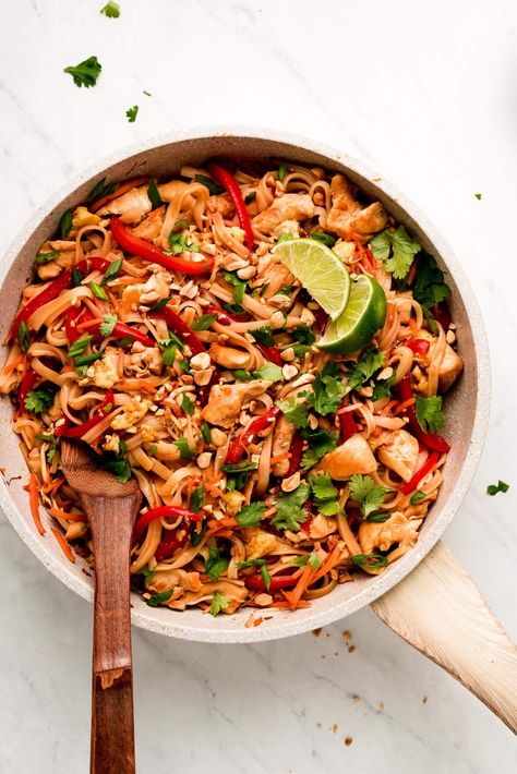 Chicken Pad Thai is a flavorful noodle stir-fry full of vegetables, chicken, rice noodles, eggs, and peanuts in a sweet and savory sauce. Make this popular dish at home in just 30 minutes! #thaifood #stirfry #asianrecipe | GarnishandGlaze.com Spicy Chicken Pad Thai, Pork Pad Thai, Egg Noodle Stir Fry, Gluten Free Pad Thai, Chicken Rice Noodles, Chicken Stir Fry With Noodles, Coconut Curry Shrimp, Vegetable Lo Mein, Peanut Curry