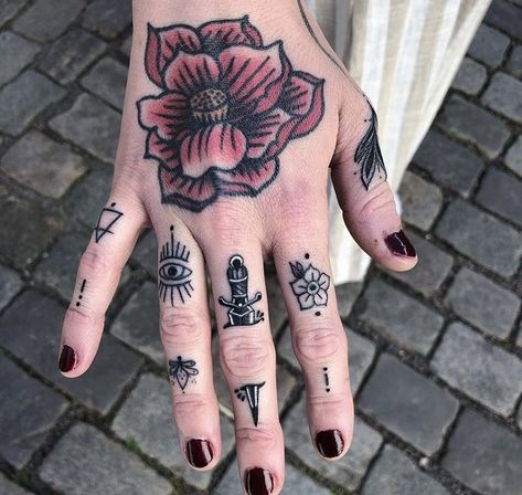 In a society captivated by grandiose ink masterpieces, small hand tattoos serve as a subtle yet impactful way to express your individuality. Finger Tattoo Trad, Sick Finger Tattoos, Neo Traditional Finger Tattoos, Traditional Style Finger Tattoos, Women Knuckle Tattoo Ideas, Eyeball Finger Tattoo, Finger Tattoo Traditional, Traditional Finger Tattoos Women, Spiderweb Finger Tattoo