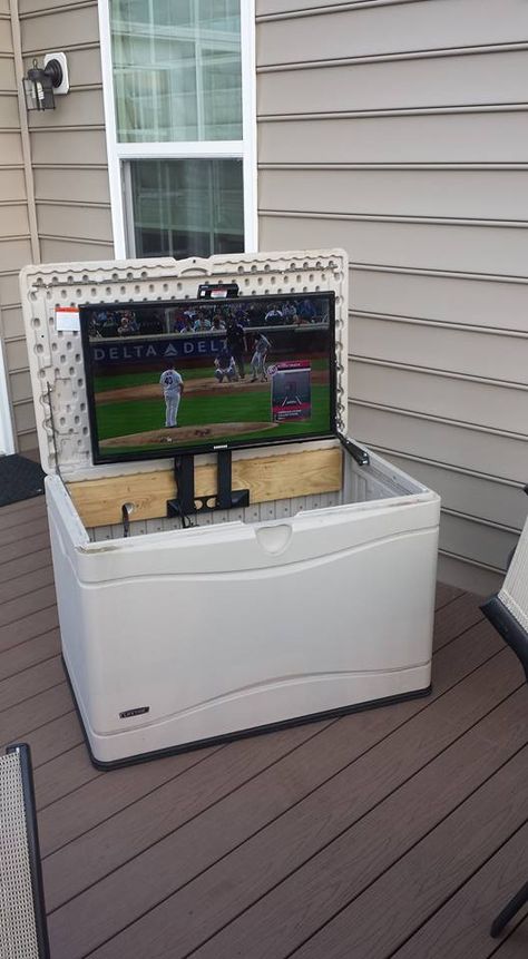 I wanted a TV on the deck. Converted a deck box to hold the TV and used a swing away TV mount turned on its side to fold the TV down into the deck box when not in use and to protect from the weather. Used a 2x6 board lag bolted from behind the box to support the TV mount Deck Tv Outdoor Tv Cabinet, Tv Outside Patio Outdoor Tv Cabinet, Garage Tv Mount, Tv On Back Porch, Covered Deck Tv Ideas, Small Patio Tv Ideas, Patio Tv Stand Ideas, Outdoor Tv On Deck, Diy Outdoor Tv Stand Ideas