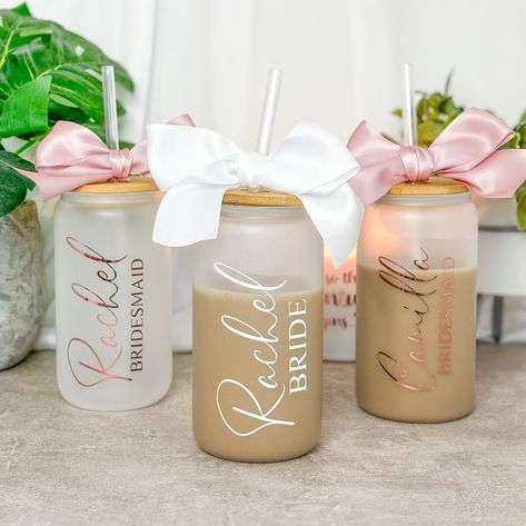 Our Personalized Coffee Tumbler with Straw is the ideal gift for your bridesmaids, adding a touch of charm to your wedding day. Key Features: Customized with the name of choice Quality frosted glass tumbler with a durable straw for sipping on the go Elegant design, perfect for bridal parties, weddings or any party and event you can think of. Reusable and eco-friendly, making it a thoughtful gift Finished of with a ribbon matching your vinyl Why Choose Our Coffee Cup: Our glass tumblers are not just drinkware; they're a personalized keepsake for your bridal party. The unique personalisation ensures each cup is one-of-a-kind, just like your friendship. Whether it's for a bridal shower, bridesmaid proposal, or a wedding favor, our personalized coffee tumbler is a stylish and meaningful choice Personalized Coffee Tumbler, Wedding Glassware, Bamboo Cups, Clear Cups, Reusable Cups, Glass Tumblers, Bridal Parties, Cup With Lid, Bachelorette Party Gifts