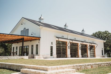 On east facade of Green Barn, add the 3 new rooms, plus an extended shade area. Can we add any decorative elements to roof line? Add plant-n faux hay door on east and west facades near roofline apex? Use exterior lamps and possible small overhangs on south facade such as shown on this photo? Venue With Garage Doors, Outdoor Wedding Venue Landscaping, Event Venue Buildings, Wedding Venue With Garage Doors, Wedding Venue Farmhouse, Barn Wedding Furniture, Pole Barn Pavilion, Barndominium Event Center, Wedding Venues Exterior