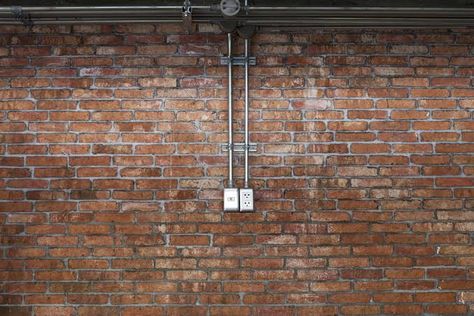 Exposed Electrical Conduit Ideas, Industrial Electrical Wiring, Exposed Conduit, Exposed Electrical, Vintage Brick Wall, Barn Remodel, Log Cabin Interior, Lighting Installation, Brick Interior