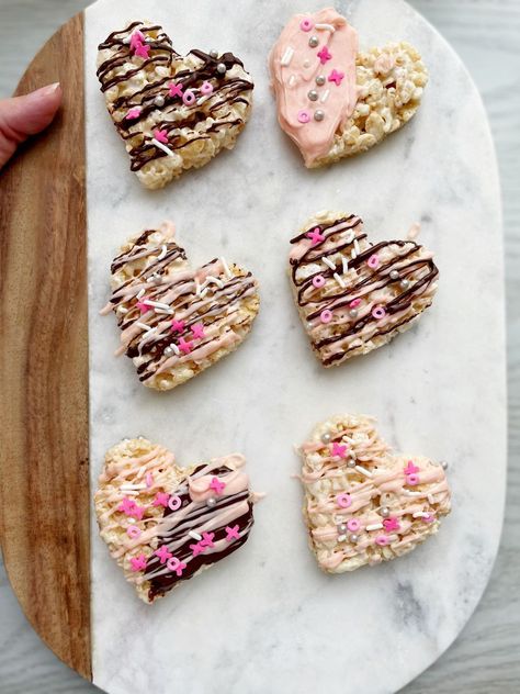 These are the Best Rice Krispie Treats for Valentine’s Day! Shaped like a heart, drizzled or dipped in white and milk chocolate and topped with sprinkles they are sure to be loved. Make these with your kids, for a party or as a gift… everyone loves the a little Valentine’s treat! Valentine Heart Rice Krispie Treats, Valentine’s Day Rice Krispie Treats, Valentines Rice Krispies, Rice Krispie Valentine Treats, Valentine’s Day Rice Crispy Treats, Gf Rice Krispie Treats, Valentines Day Rice Krispie Treats, Dye Free Valentine Treats, Rice Krispie Treats Valentines Day