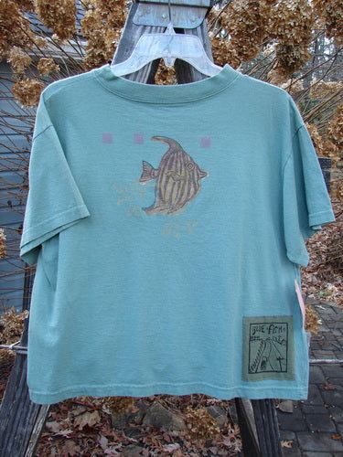 This New With Tag Short Sleeved Tee is from the Spring Collection of 1994 in Seagrass in Perfect Size 3 Condition made from Cotton Jersey. The features Include: The Very Limited Size 3 Crop Shape ~ A Wide But Slightly Shallow Thicker Ribbed Neckline ~ A Slight Bottom Flair ~ Sweet Fish Bowl Theme Paint and The Signature Blue Fish Poetry Patch! The Measurements are as Follows: Bust 44 ~ Waist 44 ~ and the Length is 22 Inches. Fish Outfit, Fish T Shirt, Fish Clothing, Ocean Shirt, Fish Shirt, Embroidered Tee, Blue Fish, Fire Fits, Fishing Outfits