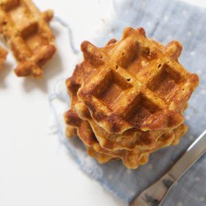 An overhead shot of a stack of sweet potato waffles with one waffle on the white background half eaten - stack of waffles is on a blue napkin Waffles For Baby, Baby First Finger Foods, Mini Waffle Recipe, First Finger Foods, Potato Waffles, How To Make Waffles, Sweet Potato Waffles, Baby Recipes, Lactation Recipes