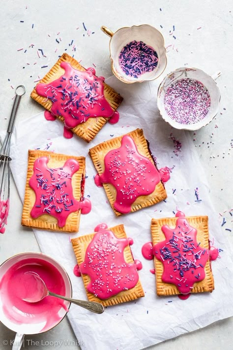 Raspberry Glazed Gluten Free Pop Tarts - With naturally dyed vibrant pink frosting, these raspberry glazed gluten free pop tarts are as pretty as they are delicious! Plus, they’re super easy to make. Gluten free dessert recipes. Homemade pop tarts. Raspberry pop tarts. Pop tart recipe. Gluten free pie crust. Easy dessert recipes. Pop tarts flavors. Pie recipes. Easy recipes. #glutenfree #dessert #recipe #poptarts Gluten Free Desserts Cookies, Gluten Free Pop Tarts, The Loopy Whisk, Loopy Whisk, Pop Tart Flavors, Poptart Recipe, Crumble Pie, Gluten Free Pie Crust, Pop Tart