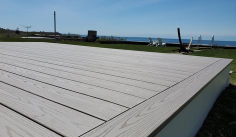 A TimberTech AZEK deck gave this Fairhaven, MA beach cottage beautiful views of Buzzard’s Bay! Our family and our customers love the maintenance-free beauty of this decking. It’s engineered to be rot, insect, stain, scratch, and fade resistant which means your TimberTech AZEK deck is ready for relaxed, maintenance-free living. #TimberTech #decking #deckingcontractor #contractor #AZEKdeck #FairhavenMA #seasideliving #coastal #buzzardsbay #maintenancefree Azek Decking Ideas, Timbertech Decking, Azek Decking, Dream Deck, Cape Cod Ma, Deck Construction, Seaside Living, Trex Deck, Deck Projects