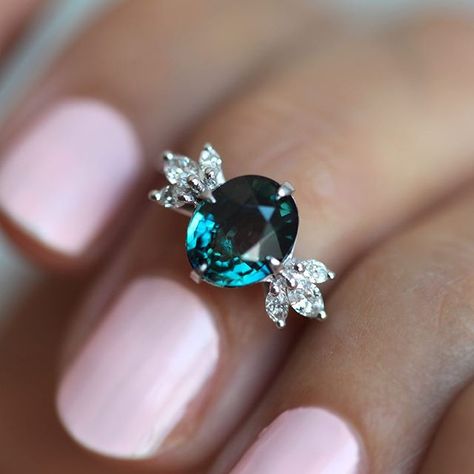 Capucinne 💎 on Instagram: “A ring that steals everyone’s attention 🦚 Our Katie ring with oval teal sapphire and marquise diamonds will be live on the site in the…” Peacock Sapphire Engagement Ring, Oval Sapphire Diamond Ring, Peacock Sapphire, Teal Sapphire Ring, Oval Sapphire Engagement Ring, Diamond Sapphire Ring, Diamond Sapphire Engagement Ring, Sapphire Diamond Engagement, Oval Engagement Ring