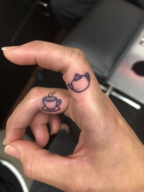 Coffee Cup Finger Tattoo, Tiny Coffee Mug Tattoo, Tea Related Tattoos, Teapot And Teacup Matching Tattoo, Coffee Mug Tattoo Ideas, Coffee Finger Tattoo, Hot Tea Tattoo, Tiny Coffee Cup Tattoo, Tiny Teapot Tattoo