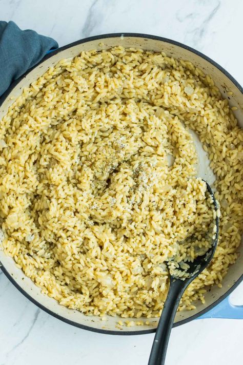 Garlic orzo risotto is a simple dish featuring orzo pasta cooked slowly in white wine and chicken broth to create a creamy, tender side dish. This recipe is super quick and requires only a handful of ingredients, making it a great option for a weeknight side dish. #risotto #orzorisotto #easyrisotto #dairyfreerisotto #healthyrisotto #orzorecipes #risottorecipes #weeknightdinner #easydinner White Wine Orzo Recipes, White Wine Orzo, Dairy Free Risotto, Italian Orzo, Healthy Risotto, Garlic Orzo, Orzo Risotto, Orzo Pasta Recipes, Easy Risotto