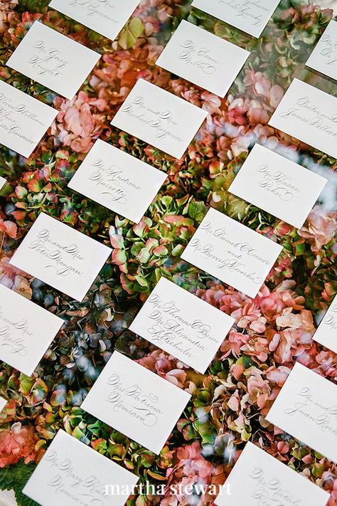 Here's a fun, unique way to play off fall's colorful foliage: RO & Co. Events and Oak & the Owl created this lucite escort card station using hydrangea blooms in a large acrylic box to reference the trees outside the venue. Laura Hooper Calligraphy added guests' names and seating chart to each note. #weddingideas #wedding #marthstewartwedding #weddingplanning #weddingchecklist Card Calligraphy, Pen Calligraphy, Hydrangea Colors, Card Table, Card Display, East Meets West, Ceremony Arch, Fusion Wedding, Calligraphy Pens