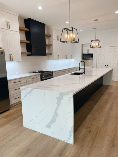 White Kitchen Black Island Modern, Farmhouse Kitchen White Countertops, Kitchen Waterfall Island Ideas, Modern Kitchen Waterfall Island, Bar Stools Kitchen Peninsula, Farmhouse Waterfall Island, Black Waterfall Island, Island With Waterfall Countertop, Black Quartz Kitchen Island