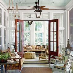 what is not to love in this picture??  A few of my favorites : hanging swing, light blue ceiling, gorgeous floor to ceiling windows, mahogany double door to gorgeous sun room.  Trying to figure out how I can make this happen in my house.......Image from Southern Living Veranda Design, Porch Kits, Screened Porch Designs, Enclosed Porch, Building A Porch, Blue Ceilings, Enclosed Porches, Enclosed Patio, Home Improvement Loans