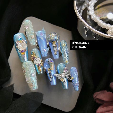 This design is inspired by the 2015 movie. The concept revolves around showcasing the magical transformation that occurs when the fairy godmother helps Cinderella turn into her elegant dress in the movie. Various background colors and aurora powder are skillfully used to achieve this fairy effect.   The dress in the movie is adorned with butterflies, and therefore this nail design also incorporates many butterfly elements throughout. The manicurist has put in special effort to handcraft the 3D pumpkin, symbolizing Cinderella's iconic pumpkin carriage.   The right hand ring finger draws inspiration from the crystal slipper in the movie. In the film, the glass slipper is adorned with beautiful butterfly. To replicate this, ice-transparent crystal with butterfly is utilized, cleverly capturin Glass Heels Slippers, Cinderella Nails Designs, Cinderella Inspired Nails, Gemstone Nails, Cinderella Quince, Fairy Pumpkin, Flashy Nails, Cinderella Nails, Quince Planning