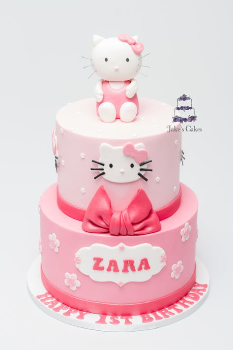 Hello Kitty first Birthday cake for little Zara with handmade Hello Kitty on top Zara Birthday Cake, Hallo Kitty Cake Birthdays, Hello Kitty Cake 2 Tier, Hello Kitty Cake Ideas Fondant, Hello Kitty Tiered Cake, Jake Cake, Hello Kitty Cake 2 Layer, Hello Kitty Theme Party, Baby Girl Birthday Cake