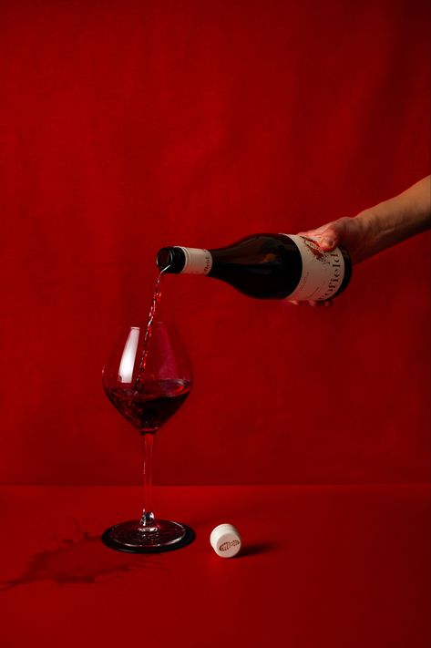 Hand pouring a glass of red wine on red backdrop Wine Pouring Aesthetic, Red Wine Product Photography, Red Wine Photoshoot, Red Wine Supernova Aesthetic, Red Wine Photography, Wine Bottle Pouring, Vino Aesthetic, Wine Commercial, Red Wine Aesthetic