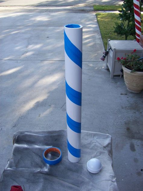 Items you will need: -  2" PVC pipe (Comes in a 10 foot length from most home improvement stores.  I cut mine into five 2 foot lengths, but you can cut whatever size suits you)-  Chain link fence post cap (2") -  Painter's tape -  Red Paint (Krylon Fusion for plastic) -  White Paint ((Krylon Fusion for plastic) Large Candy Cane Decorations Diy, North Pole Sign, Candy Cane Crafts, Pole Sign, Candy Cane Decorations, Dollar Tree Christmas, Christmas Parade, Candy Christmas Decorations, Christmas Yard