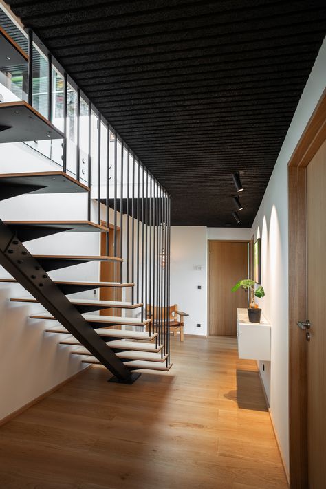 This house takes advantage of the open landscape, and its architecture highlights the dramatic landscape with simple contrast effects. Black Troldtekt line ceilings have been chosen for all rooms. The panels help create the impression of one large ceiling surface. Click the picture to see more.  #goodacoustics #holzwolleplatten #träullsplattor #woodwoolpanels #troldtekt | Architects: Sølvsten Arkitektur Wood Wool Panels, Living Room With Kitchen, Acoustics Design, Open Landscape, Windows Black, Acoustic Ceiling Panels, Dramatic Landscape, Acoustic Ceiling, Outdoor Baths