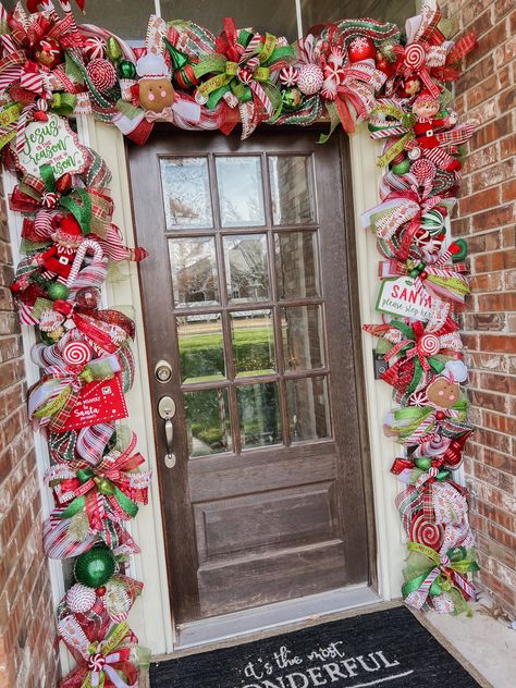 Christmas door garland made from deco mesh and multiple width wired ribbons. Ornaments & decorative bobbles secured on as well. Attached to pre-lit faux green garland. Colors are mainly red, green, grinch green, and white with Gingerbread and Candy Canes as the main theme. Candy Cane Stair Garland, Whimsical Garland Christmas, Candy Cane Christmas Garland, Gingerbread Christmas Decor Wreaths & Garlands, Candy Cane Garland Christmas Decor, Gingerbread Christmas Garland, Gingerbread Garland Ideas, Garland Doorway Christmas, Gingerbread Garland Diy