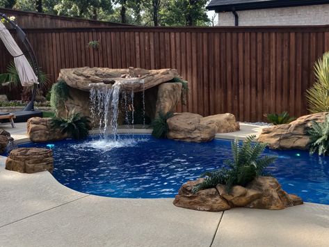 This absolutely stunning rock waterfall grotto is perfect for pools of all sizes. Universal Rocks makes it easy to transform your pool into a one-of-a-kind grotto. Waterfall In Pool Backyards, Small Pool Ideas On A Budget, Around The Pool Ideas, Waterfall Grotto, Patio Pools, Fiberglass Pool Cost, Laguna Pools, Spool Pool, Pool Waterfalls