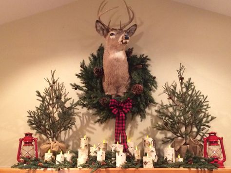 My Woodland Mantle for Christmas! Deer mount with wreath, birchbark votives, greenery and red lanterns. Mantel Decorating Ideas With Deer Mount, Wreath Around Deer Mount, Deer Head Over Fireplace, Deer Mount Christmas Decor, Deer Mount Over Fireplace, Decorate Deer Mount For Christmas, Decorating Deer Mounts For Christmas, Deer Head Christmas Decor, Deer Decorations Christmas