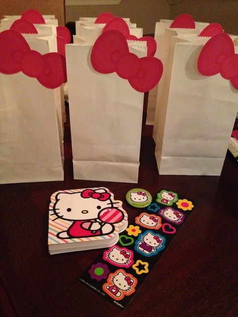 DIY hello kitty favors I made. White treat sacks from Michael's or Hobby Lobby. I googled hello kitty bow clipart and sized it down, printed, cut them and used a glue stick to attach them. Found some cute hello kitty stuff on sale at Target! DONE. Sanrio Bday, Hello Kitty Favors, Hello Kitty Birthday Decorations, Hello Kitty Stuff, Treat Box Template, Hello Kitty Baby Shower, Decoracion Hello Kitty, Nerd Party, Hello Kitty Theme Party