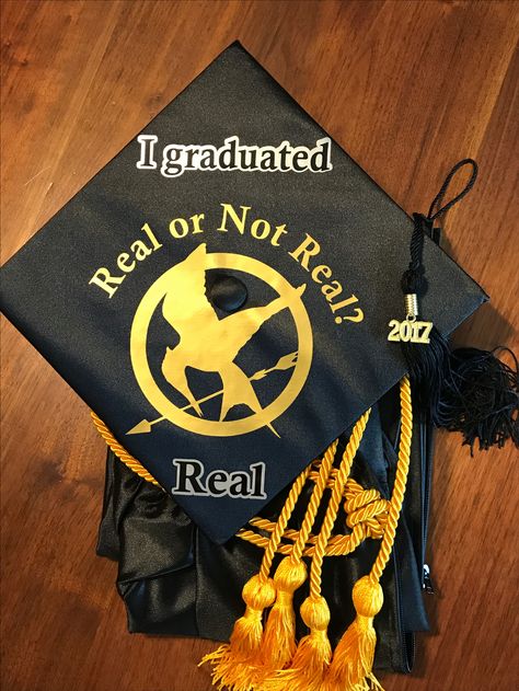 Hunger Games graduation cap! Real or Not Real? My awesome Friend Andrea helped design and make it! Hunger Games Grad Cap, Acting Graduation Cap, The Spins Graduation Cap, Pitch Perfect Graduation Cap, Stranger Things Graduation Cap, Hunger Games Graduation Cap, Fnaf Graduation Cap, Real Or Not Real, Grad Hats