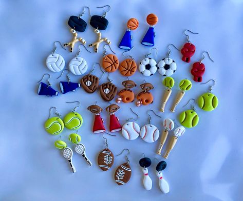 You will be game day ready with these  adorable sporty dangle clay earrings! These earrings are super cute and so fun! ️🎾⚾️🎳 🥊 🏒 📣  The football helmet, cheer megaphone, and boxing glove can be personalized with your favorite sports team color! Please message me the color you would like when purchasing. Please allow up to an additional 3-5 days shipping time with personalized earrings.  Earrings are made with polymer clay and stainless steel fixtures. Please note that all earrings are uniqu Tennis Earrings, Personalized Earrings, Cheer Megaphone, Boxing Glove, Football Helmet, Baseball Softball, Holiday Deals, Football Soccer, Gold Hoop Earrings