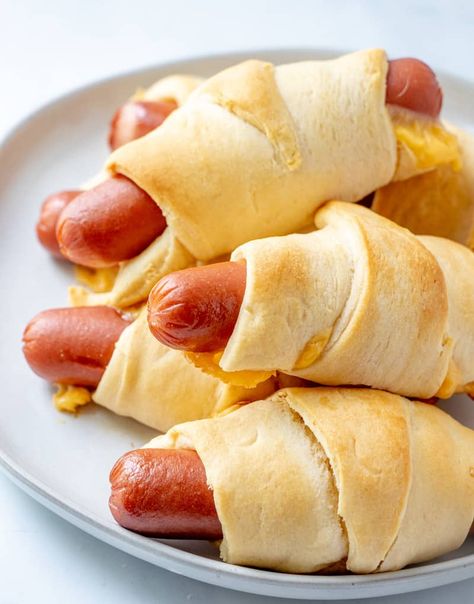 With only 3 ingredients and less than 20 minutes cook time the Crescent Dogs are an easy, family friendly recipe that the kids will love. #recipe #kidfriendly #hotdogs #crescentrolls #easyrecipe #cheesy Crescent Dogs With Cheese, Biscuit Wrapped Hot Dogs, Hot Dog Wrapped In Crescent Roll, Hot Dogs Wrapped In Crescent Rolls, Hotdogs In Crescent Rolls, Crescent Wrapped Hot Dogs, Assorted Sandwiches, Christmas Vbs, Hot Dog Crescent Rolls