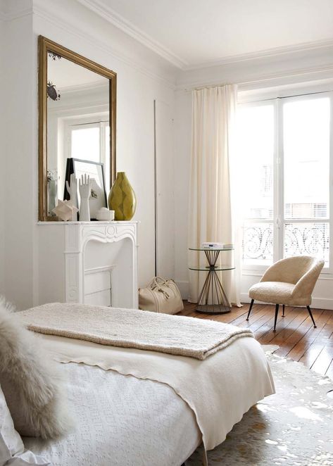 Parisian bedroom with beige accent chair, beige linens, white marble fireplace, gold mirror via Cote Maison Emilie Bonaventure Parisian Style Bedrooms, Parisian Bedroom Ideas, Parisian Bedroom Decor, Cozy Living Room Furniture, Parisian Living Room, Parisian Bedroom, Parisian Decor, French Bedroom, Ideas Hogar