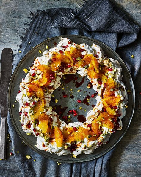 Negroni meringue pavlova wreath with pomegranate and pistachio recipe | delicious. magazine Light Christmas Dessert Recipes, Light Christmas Dessert, Meringue Wreath, Pavlova Wreath, Christmas Pavlova, Tartiflette Recipe, Meringue Pavlova, Pistachio Recipes, Pavlova Recipe