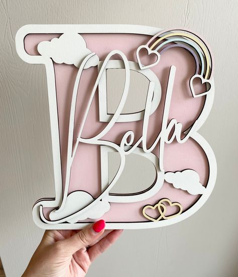 PLEASE SEE LEAD TIMES - 3/5 weeks - Feel free to message me and if I can be sooner I will but I can't always accommodate.  Personalised wall decor for a bedroom, nursery - the perfect gift! This listing is for a 25 cm size 3D letter.  They are cut from 3mm thick mdf using double thickness for finished product- painted in your choice of your colours. overall depth is 6mm.  Please note that name sizes will vary slightly depending on the characters in the name. The height is determined by the first Girly Name, Door Name, Personalized Wall Decor, Laser Cut Wood Crafts, Mdf Crafts, Laser Engraved Ideas, Wood Personalized, Wooden Letter, Bedroom Door