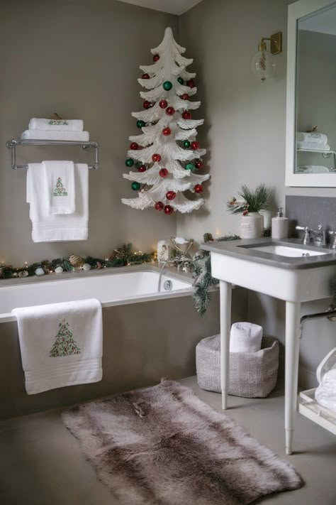 A neutral-toned bathroom with festive Christmas decor, featuring white Christmas tree, garlands, holiday towels, and soft lighting for a cozy holiday feel. Vintage Christmas Bathroom, Christmas Bathroom Decor Ideas, Holiday Bathroom Decor, Pottery Barn Style, Holiday Bathroom, Christmas Bathroom Decor, Neutral Christmas, Christmas Bathroom, Holiday Ready