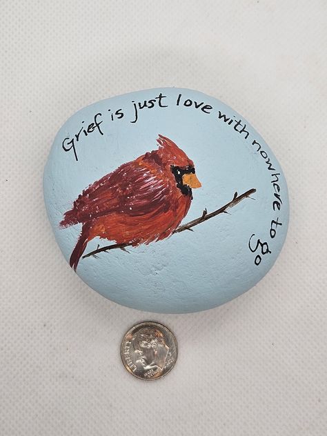 This is a hand painted rock of a red cardinal sitting on a branch. Perfect addition to a memorial garden. This rock can be personalized- it is unfinished so initials or a name can be added.  This is a simple and elegant design- perfect gift for someone who lost a loved one. Painted in flat and metallic acrylics and WILL BE finished in UV/ Water resistant acrylic sealant once personalization is chosen. Sky blue background with simple red cardinal sitting on a branch with on of my favorite sympathy quotes written around the rock.  Around the cardinal is delicate pearled white halo. This is a rock found on hikes with small imperfections found in nature- please look at pics carefully!  Perfect for sympathy gift and appropriate for your indoor decor or your outdoor garden! Memorial Rock Garden Ideas, Memorial Rocks Painted, Memorial Stones Diy, Painted Christmas Rocks, Memorial Rocks, Sky Blue Background, Sympathy Quotes, Diy Rock Art, Rocks Painted