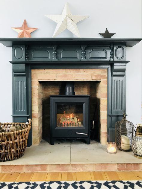 Dark grey fire surround in Farrow & Ball Downpipe with wood burner Fire Surround Ideas, Woodburner Surround, Farrow Ball Downpipe, Fireplace Surround Diy, Wood Fireplace Surround, St Cyprian, Fireplace Hearth Tiles, Wooden Fire Surrounds, Lounge Makeover