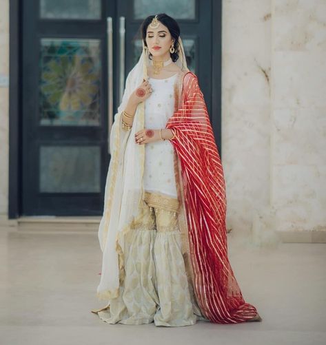 Pairing neutrals with a simplistic red dupatta make the most glorious brides because no color screams bride as the color red.  out our blog to see all the latest ideas for bridal dresses: https://blog.bridals.pk/categories/bridal-dresses/  #bridalspk #bridalspkglam #bridalspkbeauty #dailydosebridalspk #pakistanibride #bridaldress #bridalmakeup #bridaljewelry #allthingsbridal #jewelry #bridalinspiration #bridestyle #bridetrends  Via: asadiqbaaal Nikah Bride, Nikkah Ideas, Nikah Dresses, Nikkah Brides, Nikkah Outfit, Nikkah Bride, Red Dupatta, Eastern Dresses, Nikah Dress