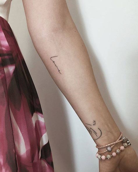 “Love” temporary tattoo on the inner forearm. Inner Arm Script Tattoos For Women, Script Tattoo On Arm, Forearm Script Tattoo, Forearm Word Tattoo, Tato Lengan Bawah, Rib Tattoos Words, Font Tato, Wörter Tattoos, Girl Shoulder Tattoos