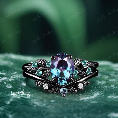 - Metal :The underneath metal is in Silver/ 10K/14K/18K white gold, coated with black rhodium Oval cut Alexandrite Engagement ring Black Gold Promise Ring Leaf Nature Inspired Ring Gothic Color changed Gemstone Bridal Ring sets Ring Details: - Theme:Romantic Wedding & Engagement - comfortable band - Stone:6*8mm lab alexandrite(Blue-green in daylight, purple-red in incandescent light.) Side stones: lab created emerald  - Total weight: 0.09 ctw (High Quality) - Color: D-F - Clarity: VVS1 - ring ba Black Wedding Ring Sets Couple, Dark Blue Sapphire Engagement Ring, Elven Wedding Ring, Magical Engagement Rings, Teal Ring, Daylight Ring, Black Gemstone Ring, Teal Sapphire Engagement Ring, Engagement Ring Black