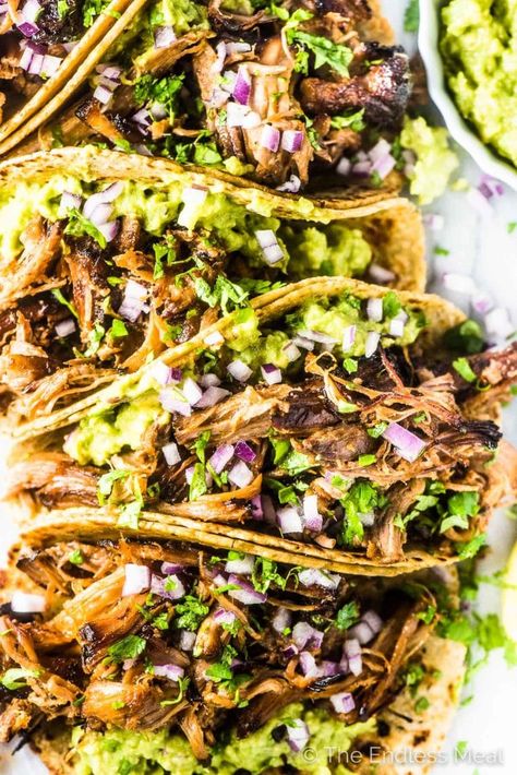 SAVE FOR LATER! Carnitas Tacos (pulled pork tacos) are THE BEST ever! The slow cooker Mexican pork is unbelievably tender and flavorful. Add a scoop of guacamole to a tortilla (or lettuce wrap!), top with a big pile of pulled pork and dig in! #theendlessmeal #carnitas #carnitastacos #tacosdecarnitas #tacos #pulledpork #pork #porktacos #glutenfree #paleo #cincodemayo #mexican #mexicanrecipes #porkrecipes #tacorecipes Tacos Pulled Pork, Mexican Pork Carnitas, Best Carnitas, Mexican Pulled Pork Tacos, Carnitas Tacos Recipe, Pork Carnitas Tacos, Mexican Pulled Pork, Mexican Pork, Guacamole Recipe Easy