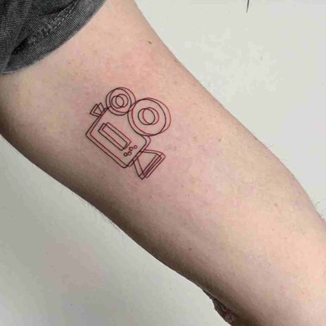 87 Camera Tattoo Ideas for Minimalist Photographers - TattooGlee Film Minimalist Tattoo, Film Tattoos Ideas, Filmmaking Tattoo Ideas, Minimalist Photography Tattoo, Film Tattoo Ideas Camera, Film Tattoos Minimalist, Cute Movie Tattoos, Filmmaker Tattoo Ideas, Camera Minimalist Tattoo